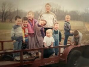Children riding on red trailer